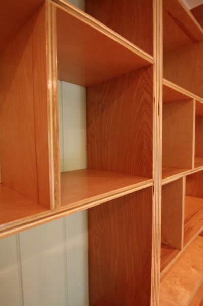 Exposed-edge plywood bookshelves built for a couple of ghost-writers.