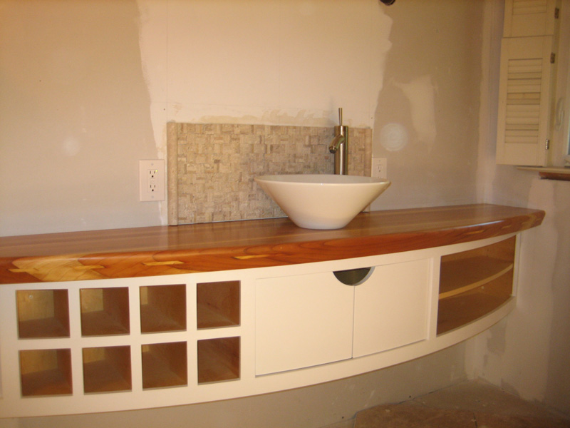 Curved vanity with solid redwood top.
